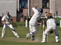 Robert drives back past the bowler.jpg